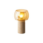 Cut-out of this Clérachic table lamp in its taller column form, lit, with an amber glass shade on a white backdrop.