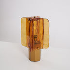 Unlit Clérachic table lamp turned slightly to one side, so the layered amber glass panels and the six-sided base show clearly.