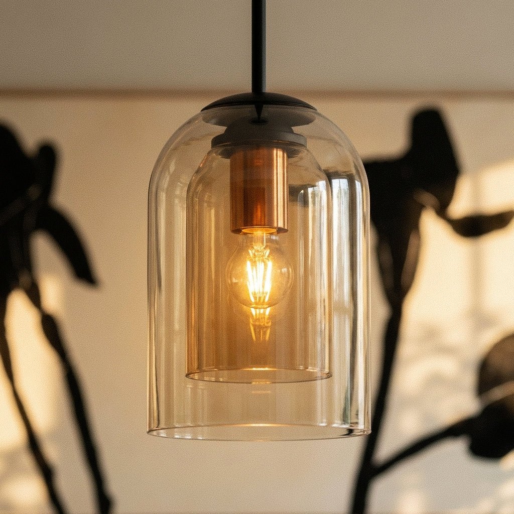 This close view of the Clérachic amber pendant's stacked glass layers glows warmly among dried stems.