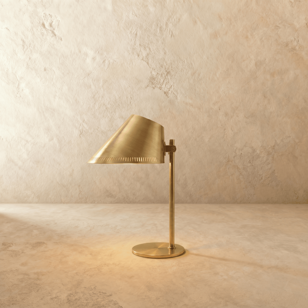 Clérachic table lamp in vintage brass with an angled cone shade on a slender stem and round base.