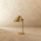 Clérachic table lamp in vintage brass, close view of the angled cone shade and adjustable joint.