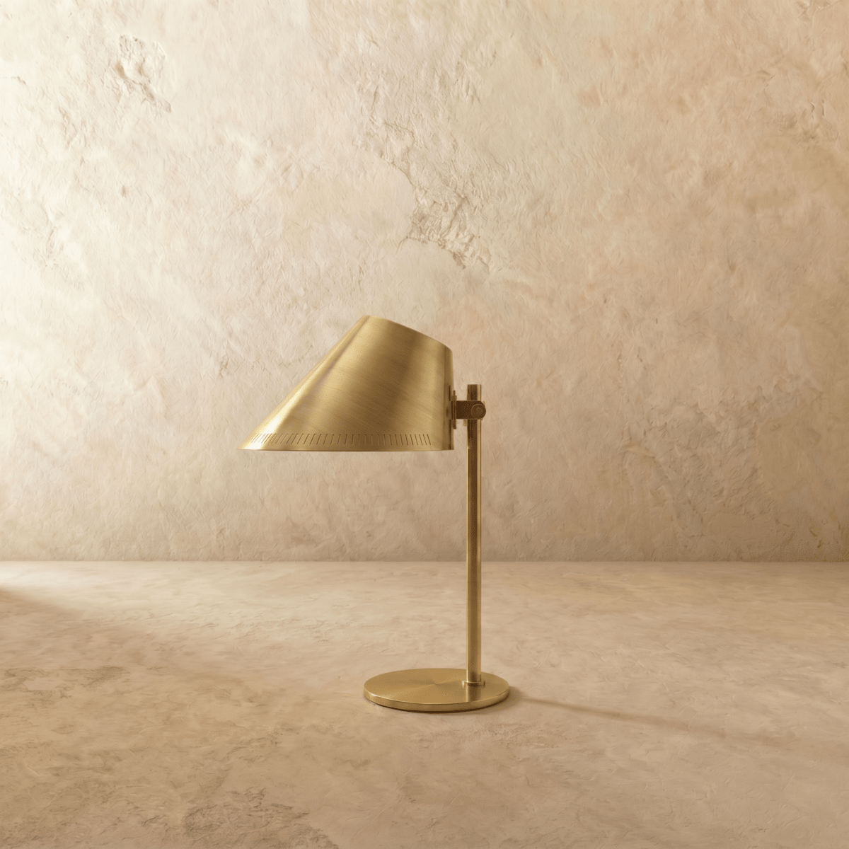 Clérachic table lamp in vintage brass, close view of the angled cone shade and adjustable joint.