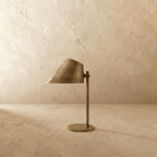 Clérachic table lamp in satin brass, front view of the angled cone shade and round metal base.
