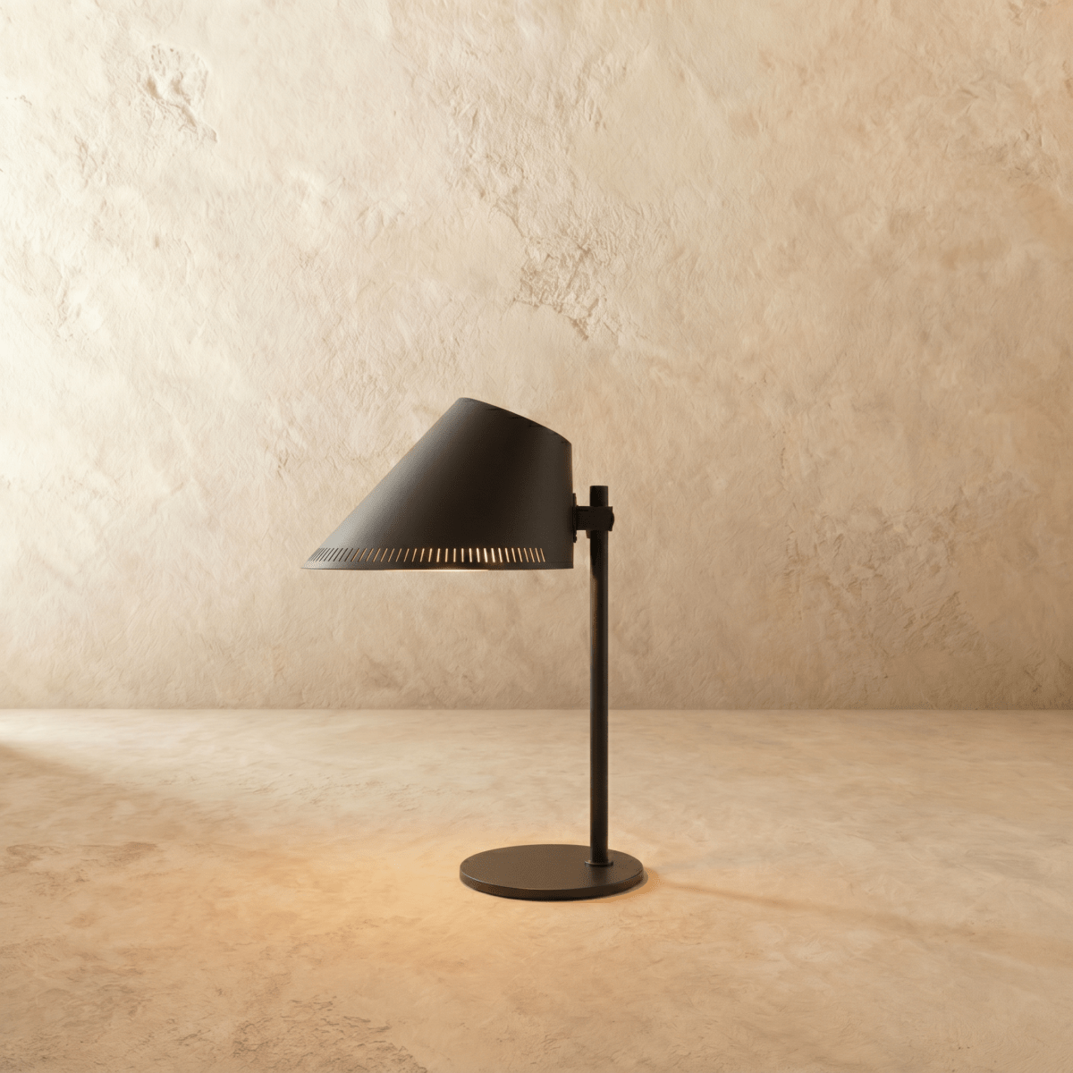 Clérachic table lamp in matte black with an angled cone shade on a slender stem and round base.
