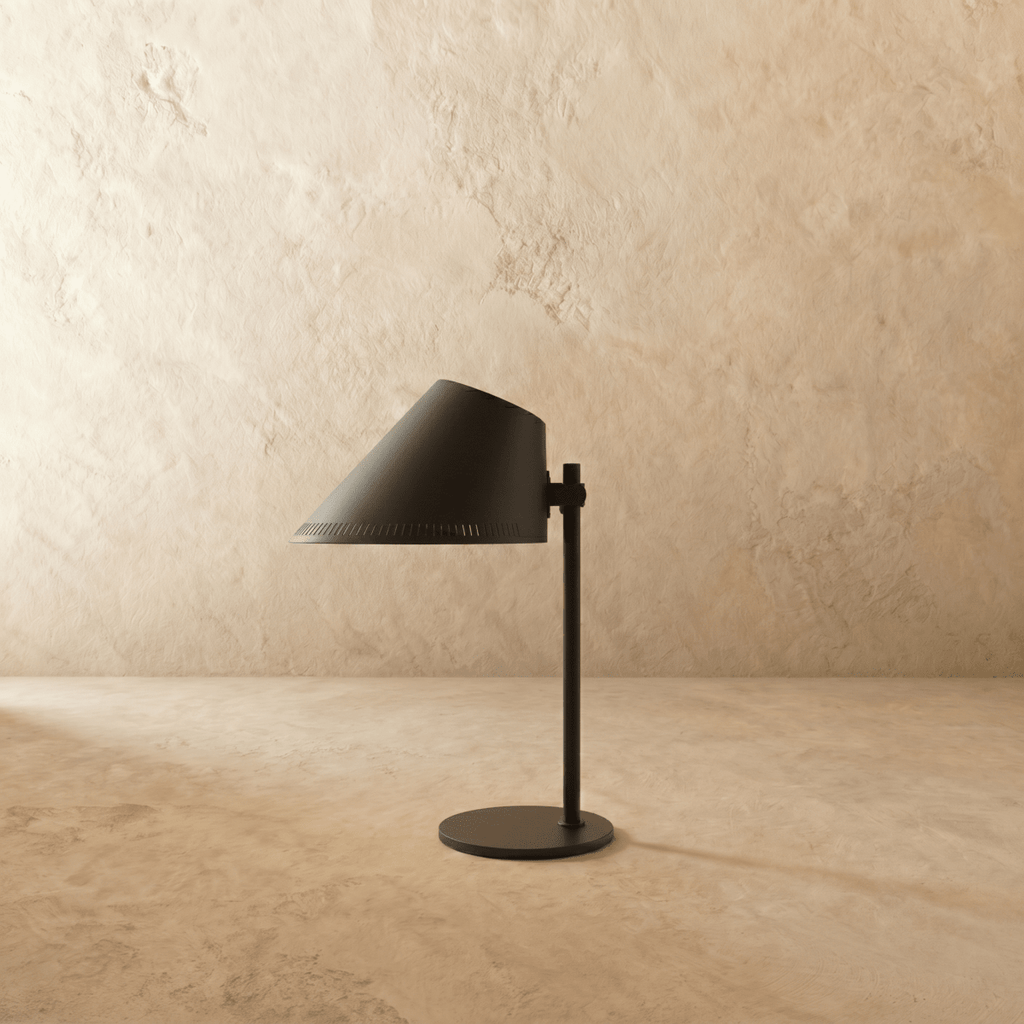 Clérachic table lamp in matte black, close view of the angled cone shade and adjustable joint.