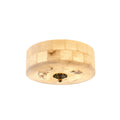 Round Clérachic alabaster ceiling light with a rough stone underside patch and a brass centre cap, seen from slightly below.