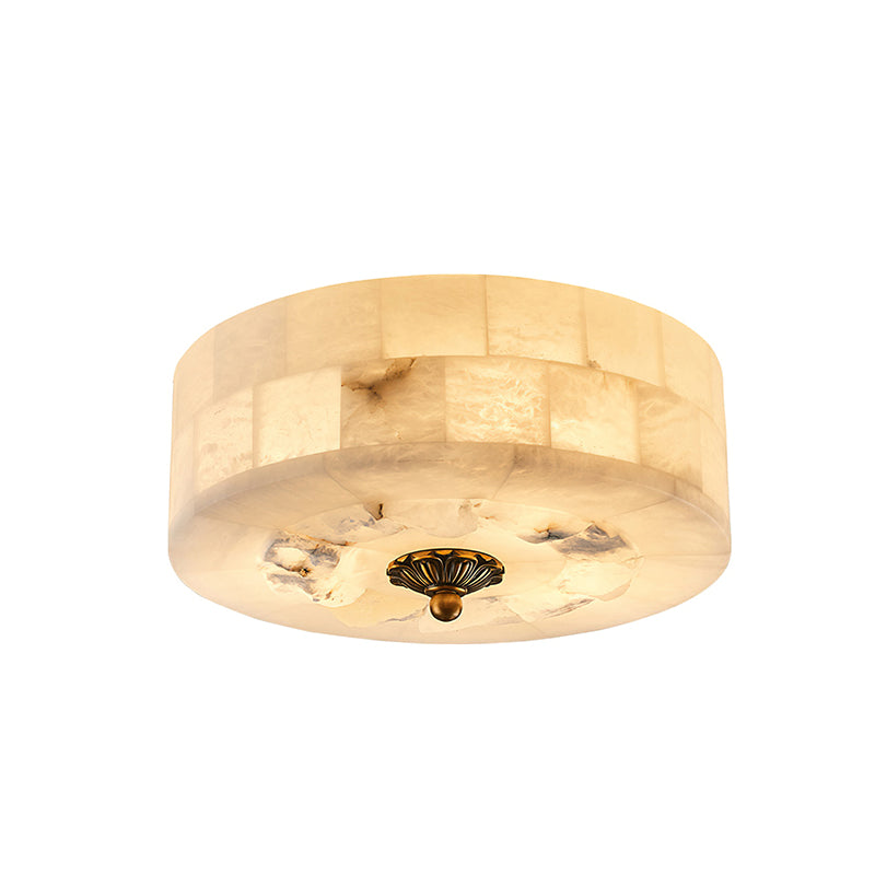 Round Clérachic alabaster ceiling light, seen from a slightly different angle, with the rough stone patches beside the brass cap.