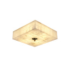 Square Clérachic alabaster ceiling light seen from below at a corner, lit, with a brass centre cap and tiled stone sides.