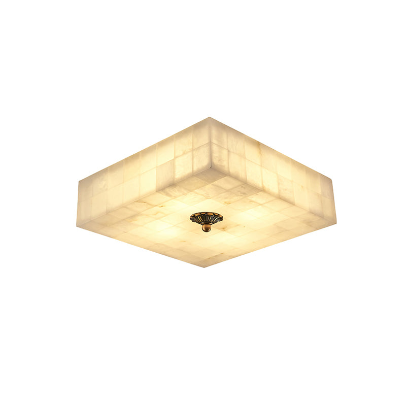 Smaller square alabaster ceiling light from Clérachic, lit, with a single brass centre cap on its tiled underside, on white.