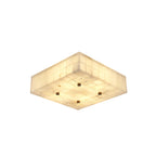 Wide square Clérachic alabaster ceiling light with a glowing tiled underside and four brass studs, on a white backdrop.