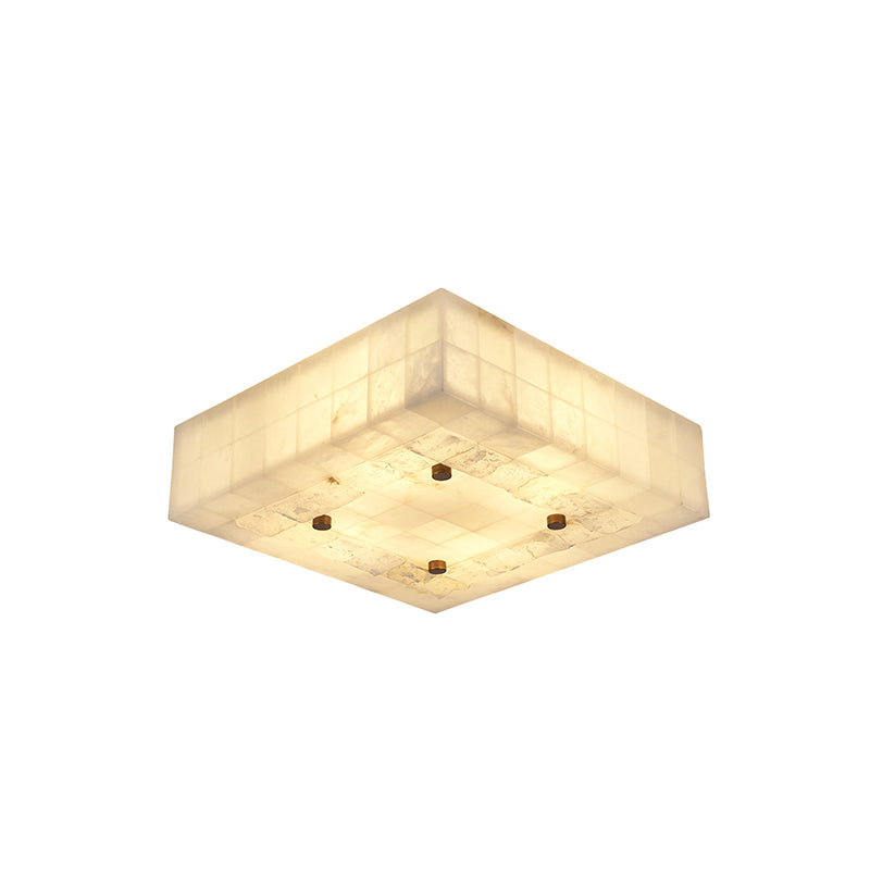 Wide square Clérachic alabaster ceiling light with a glowing tiled underside and four brass studs, on a white backdrop.
