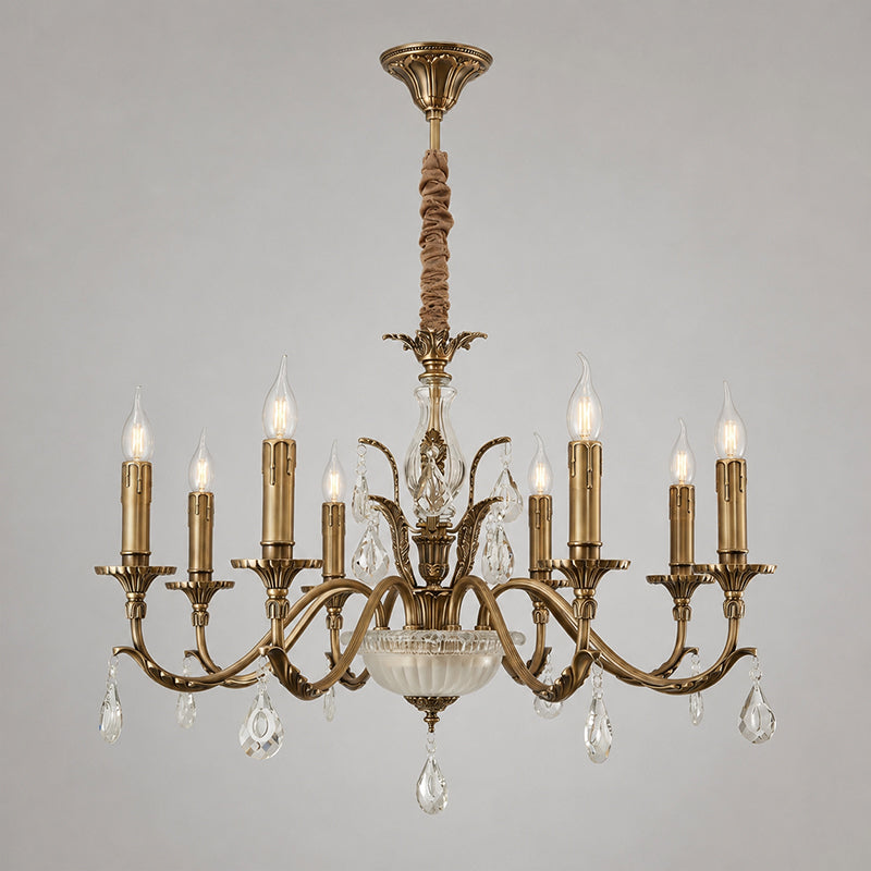 Seen from the front on a plain grey backdrop, a Clérachic antique brass chandelier hangs by a fabric-wrapped rod from a brass ceiling cap.