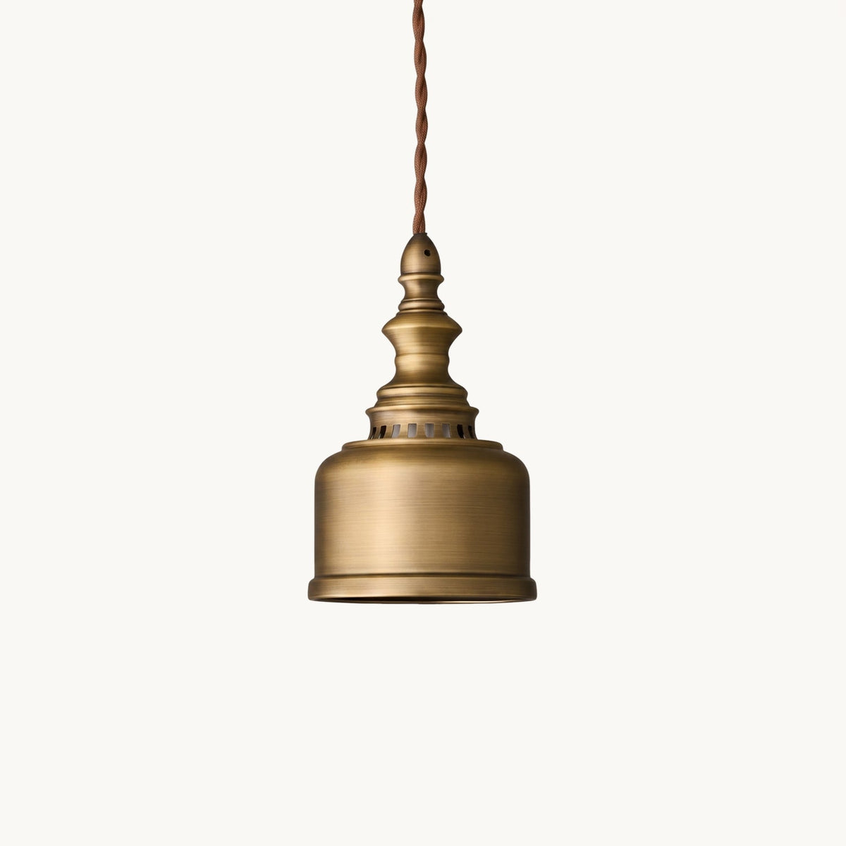 A Clérachic antique brass pendant with a bell-shaped dome and twisted cord, on a plain off-white backdrop.