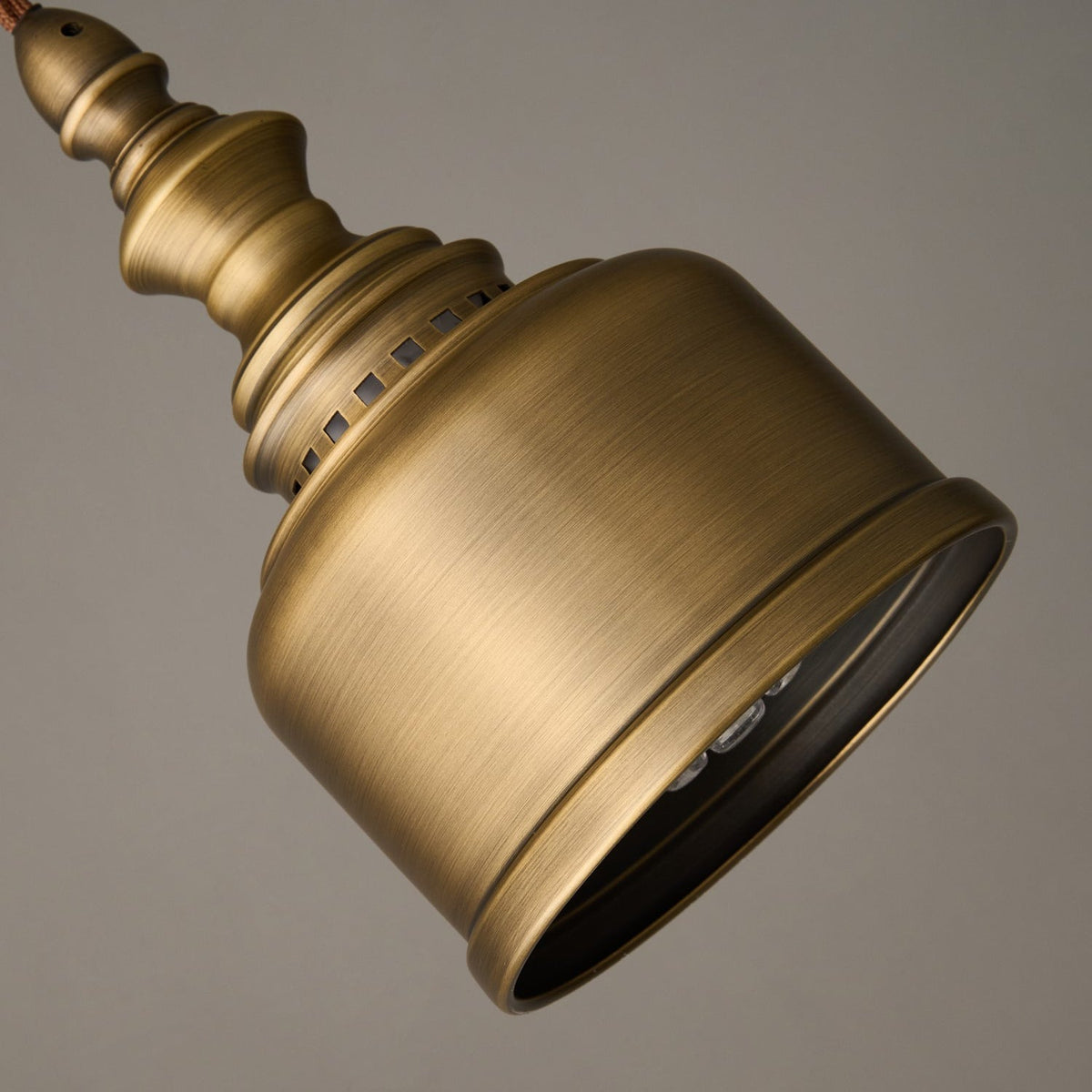 Looking up into the open mouth of this Clérachic brass shade, with the bulb just visible and the brushed metal catching the light.
