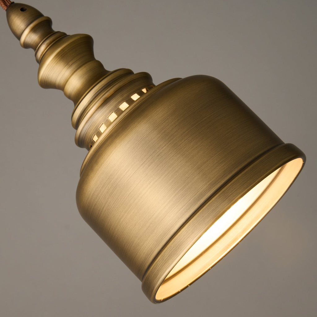 Close view of the lit rim of this Clérachic brass dome, the inside glowing warm white against the brushed outer surface.