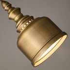 Close view of the lit rim of this Clérachic brass dome, the inside glowing warm white against the brushed outer surface.