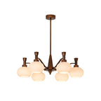 Smaller trumpet-arm Clérachic chandelier with cream glass globes and a long bronze rod, on a plain white backdrop.