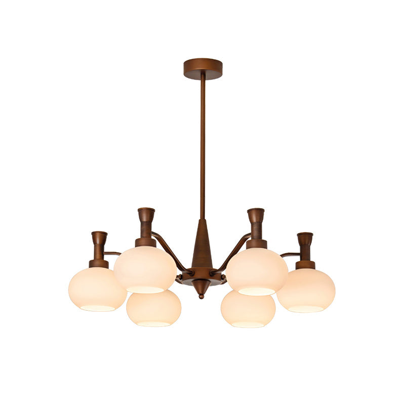 Smaller trumpet-arm Clérachic chandelier with cream glass globes and a long bronze rod, on a plain white backdrop.