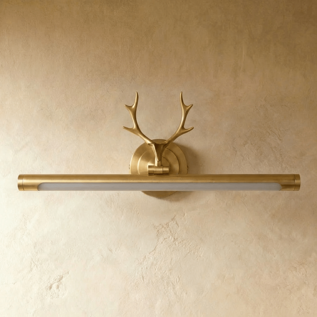 Clérachic brass antler wall light with its long 55 cm tube switched off, showing a frosted diffuser, on a plaster wall.