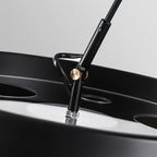 Close view of the joint where the arm meets the shade on this Clérachic arc floor lamp, with a small gold-toned knob.