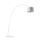 White Clérachic arc floor lamp with a pale grey drum shade and a white round base, shown on a plain white background.