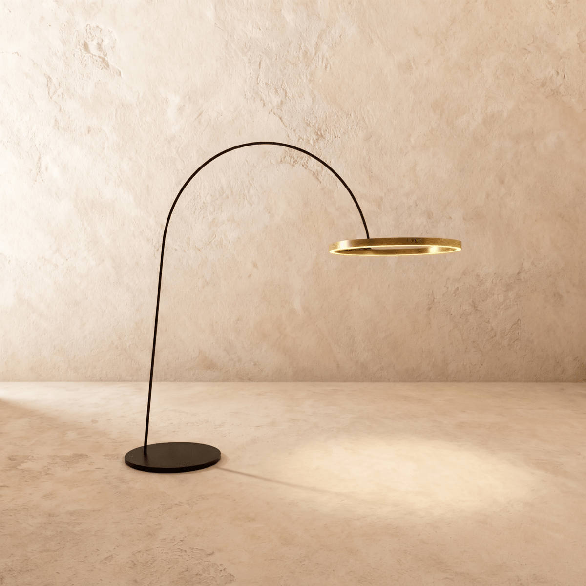 Clérachic arc floor lamp with a thin black arm and a gold ring light, on a round black base against a limewash wall.