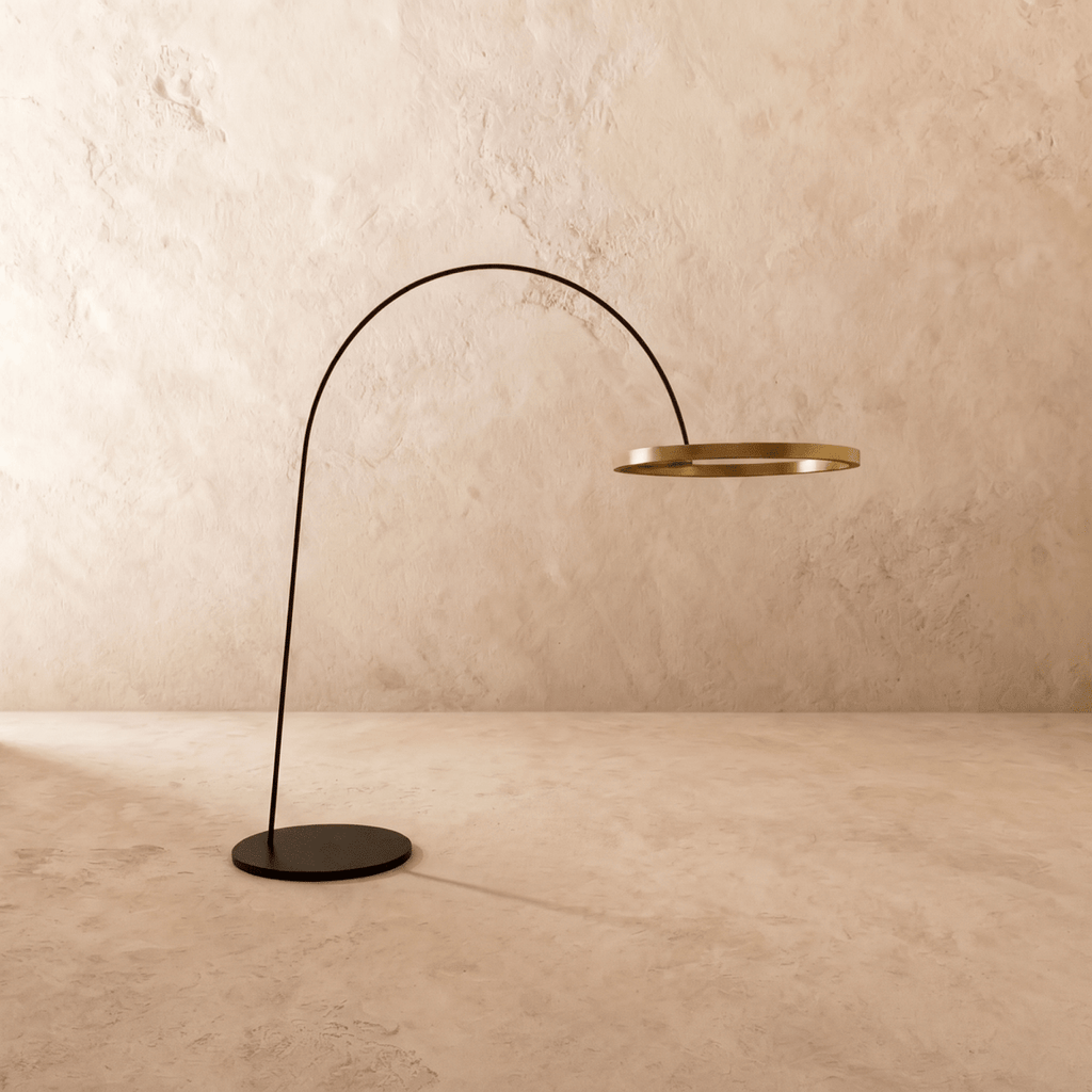 Clérachic arc floor lamp with the gold ring switched off, showing its brushed finish on a black arm and base.