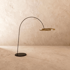 Clérachic arc floor lamp with the gold ring switched off, showing its brushed finish on a black arm and base.