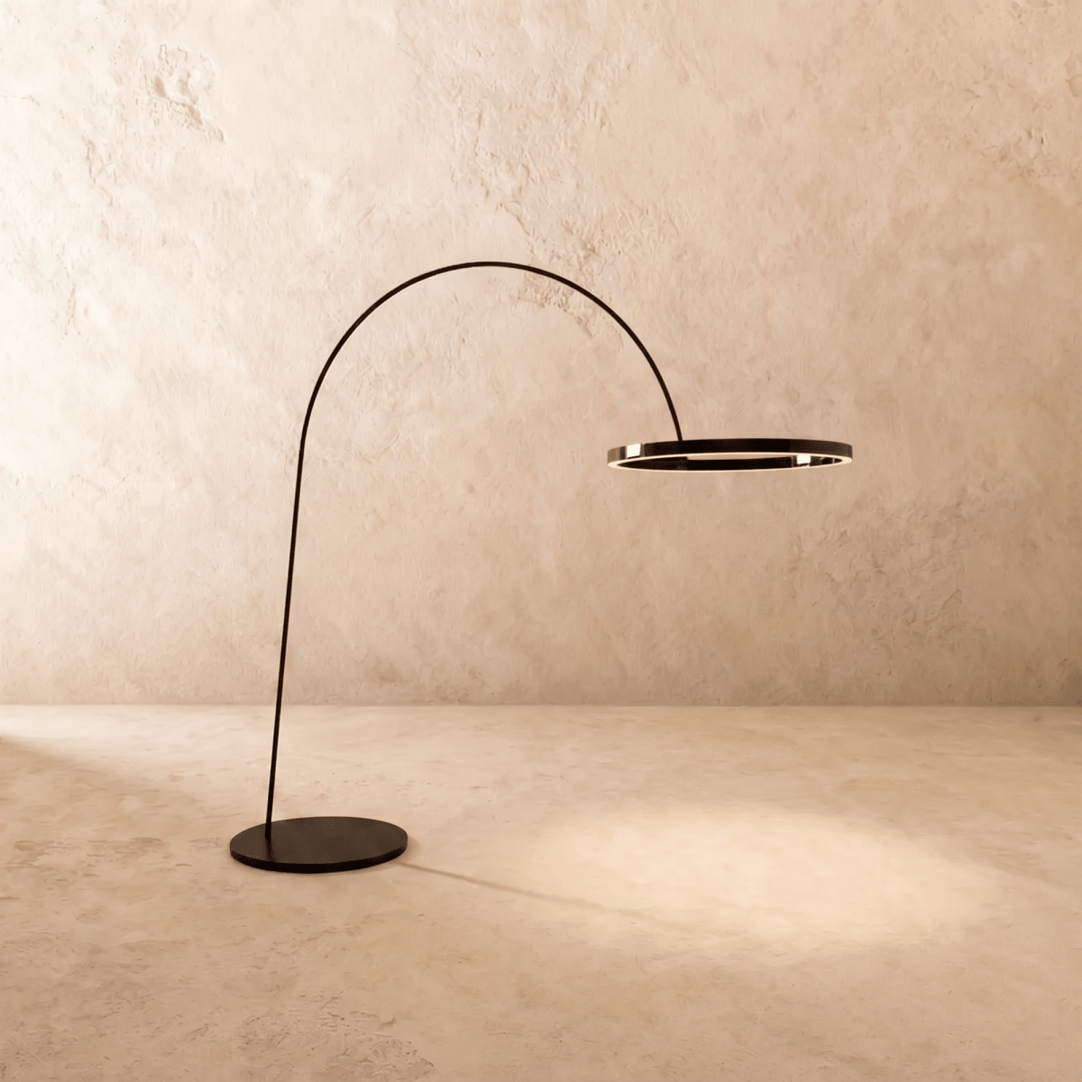 Clérachic arc floor lamp with a black ring light on a slim black arm and round base, lit warmly above a limewash floor.