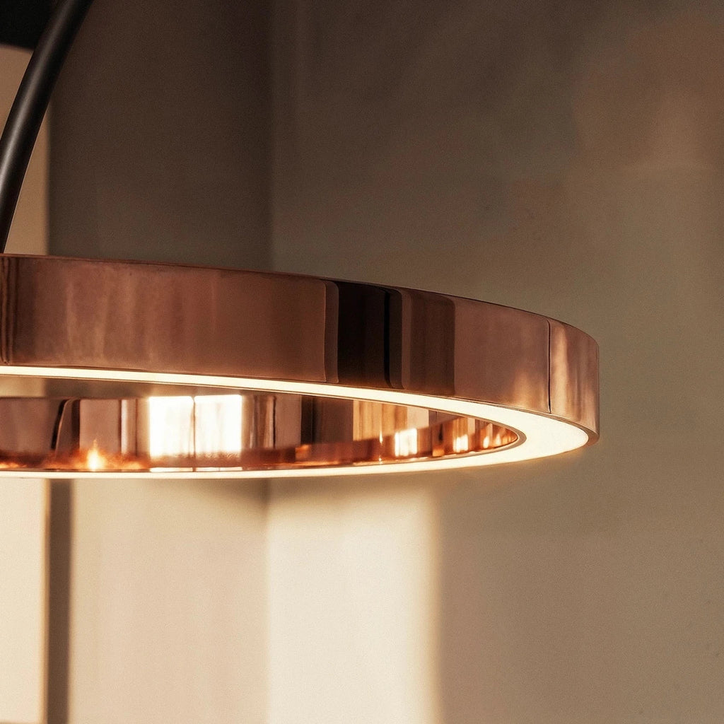 Close view of the Clérachic rose gold ring light, with its polished outer face and a warm glow along the inner edge.