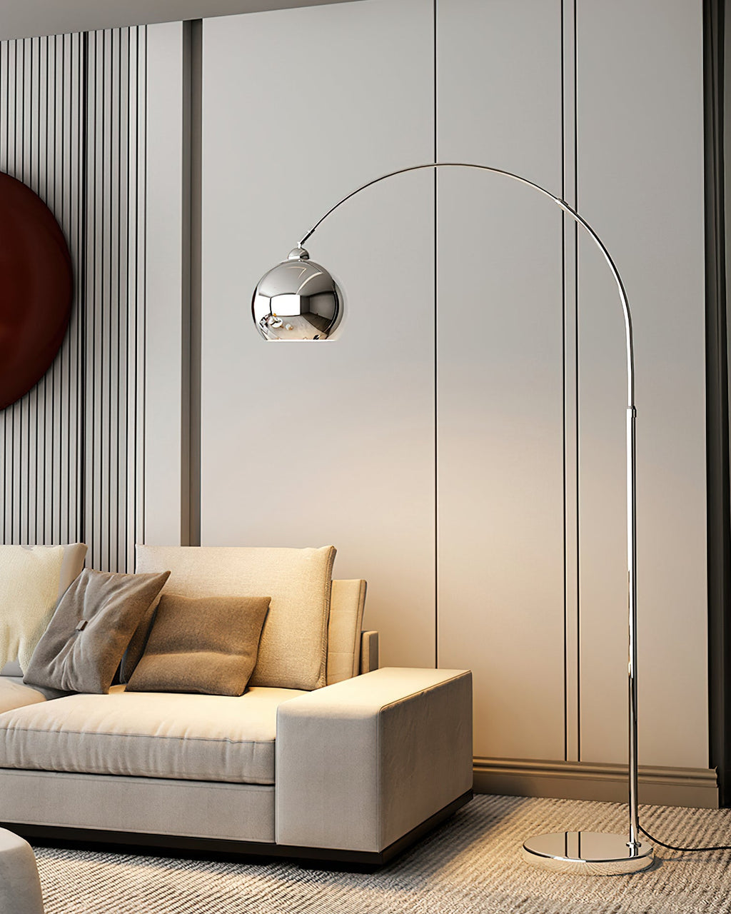 Seen from a low angle, a Clérachic chrome arc lamp stands behind a beige sofa, with fluted panels and a dark round art piece.