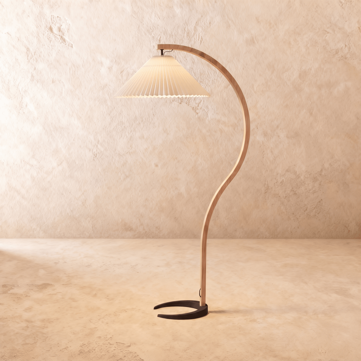 Clérachic arched floor lamp with a warm beige pleated shade, a curved wooden stem and a dark horseshoe base.