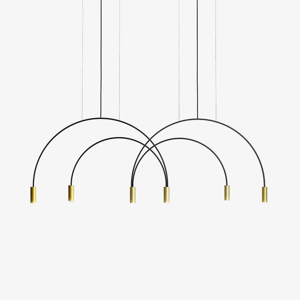 Black crossing arches ending in six brass spot heads, this Clérachic pendant light on a plain white backdrop.