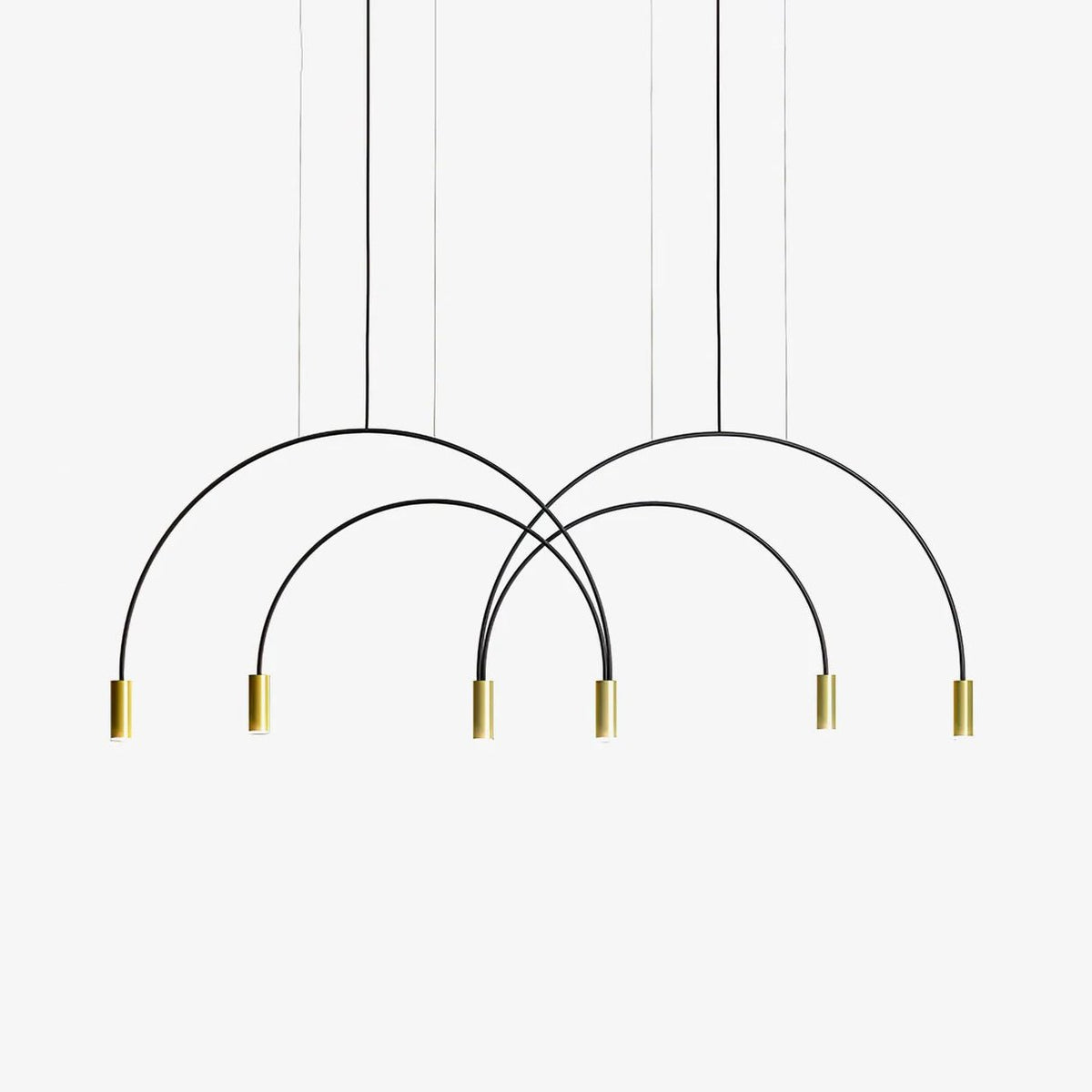 Black crossing arches ending in six brass spot heads, this Clérachic pendant light on a plain white backdrop.