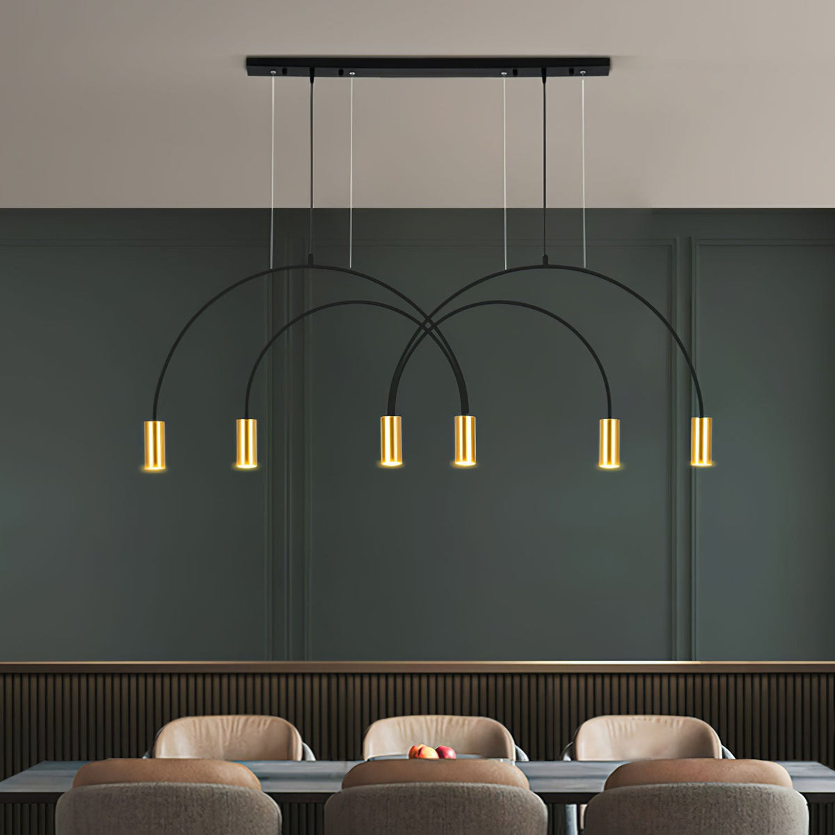 Six brass spot heads glow under the crossing black arches of this Clérachic pendant, in front of a deep green wall and tan dining chairs.