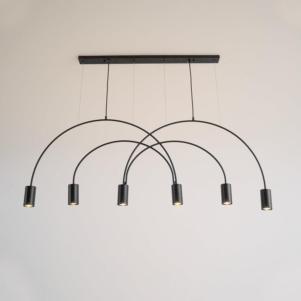 Front view of this Clérachic arch pendant in black, six spot heads below a slim canopy bar on a pale wall.