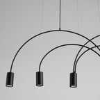 Close view of three black cylindrical spot heads and the thin round arches that carry them on this Clérachic pendant.