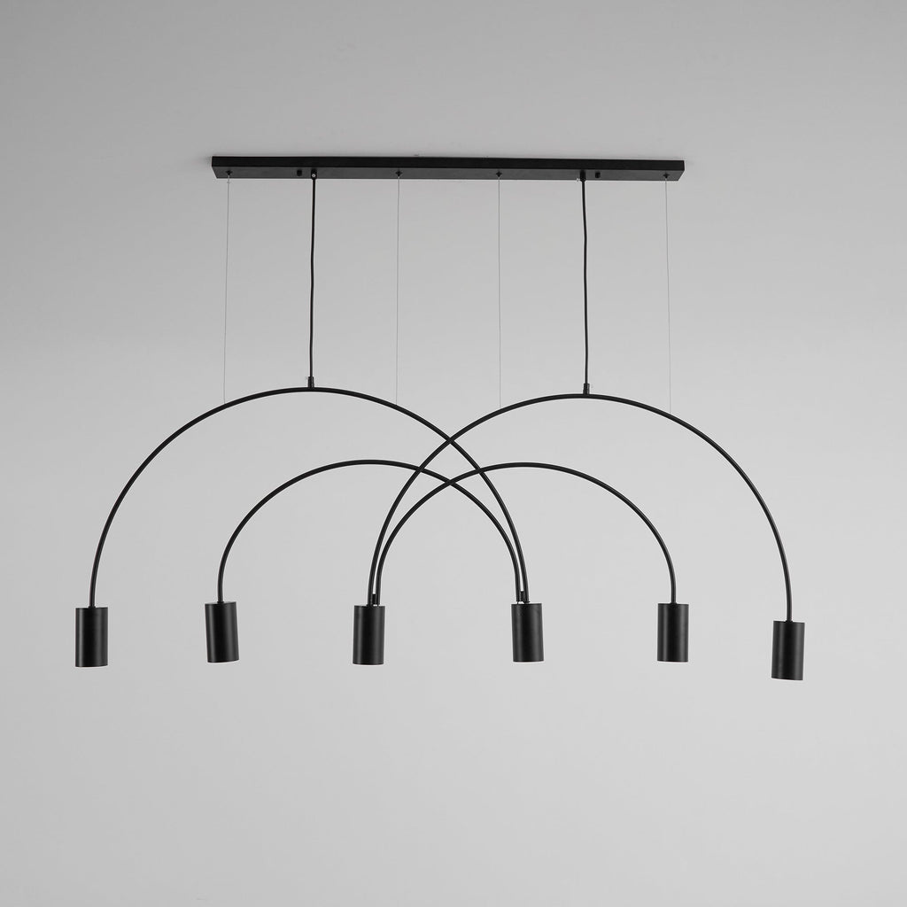 Black Clérachic arch pendant on a pale grey backdrop, six spot heads hanging below overlapping arches.
