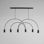 Black Clérachic arch pendant on a pale grey backdrop, six spot heads hanging below overlapping arches.