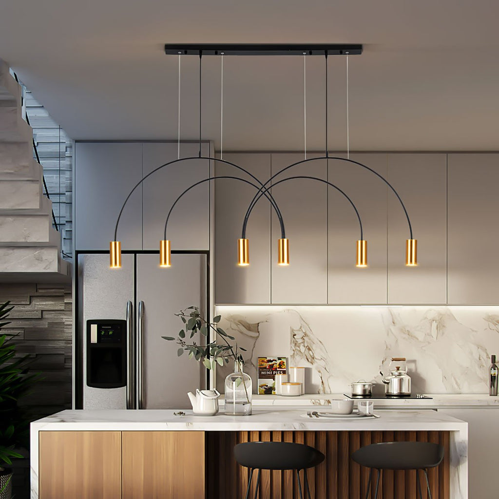 Lit brass spot heads on this Clérachic arch pendant, hung over a marble-backed kitchen island with black bar stools.