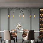 Six lit brass spot heads hang from black arches on this Clérachic pendant, over a marble dining table and tan chairs.