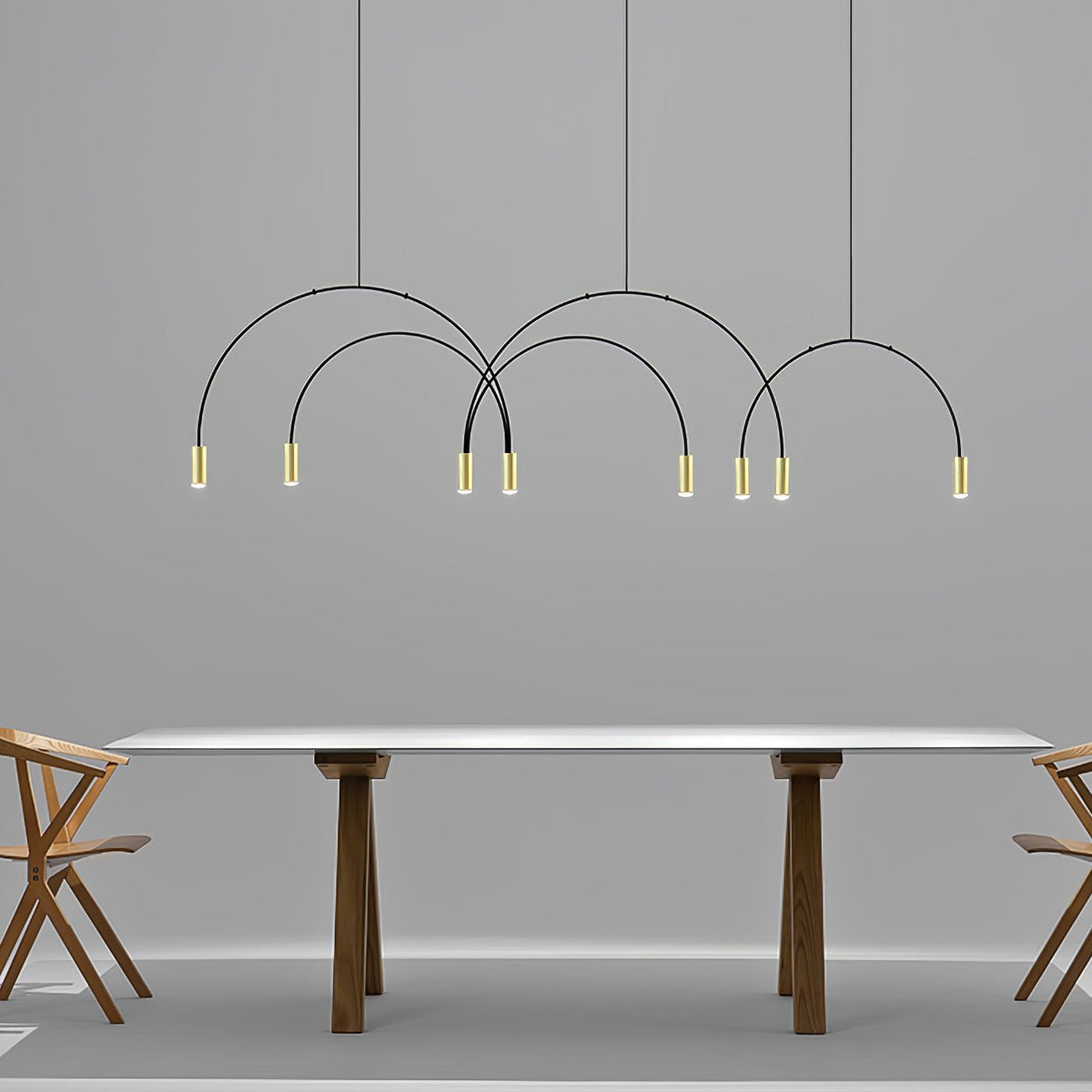 Eight small brass spot heads hang from thin black arches on this Clérachic pendant, above a long white table with walnut legs.