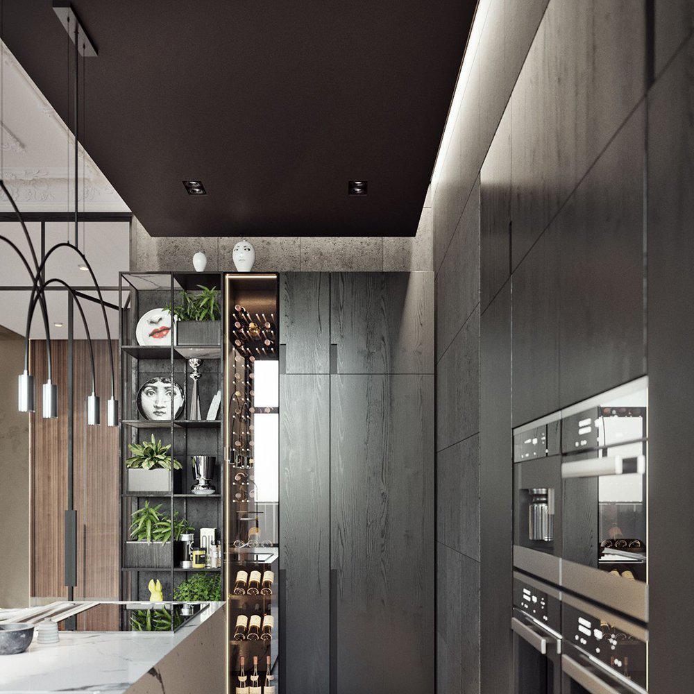 Seen at the edge of a dark kitchen, this Clérachic arch pendant hangs near a wine rack and built-in ovens.