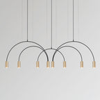 Eight brass spot heads hang from four black arches on this Clérachic pendant, against a pale grey backdrop.