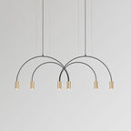 Six brass spot heads under two crossing black arches, this Clérachic pendant on a soft grey backdrop.