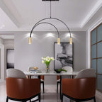 Over a marble dining table, this Clérachic pendant has two nested arches, three lit brass spot heads and a slim canopy.