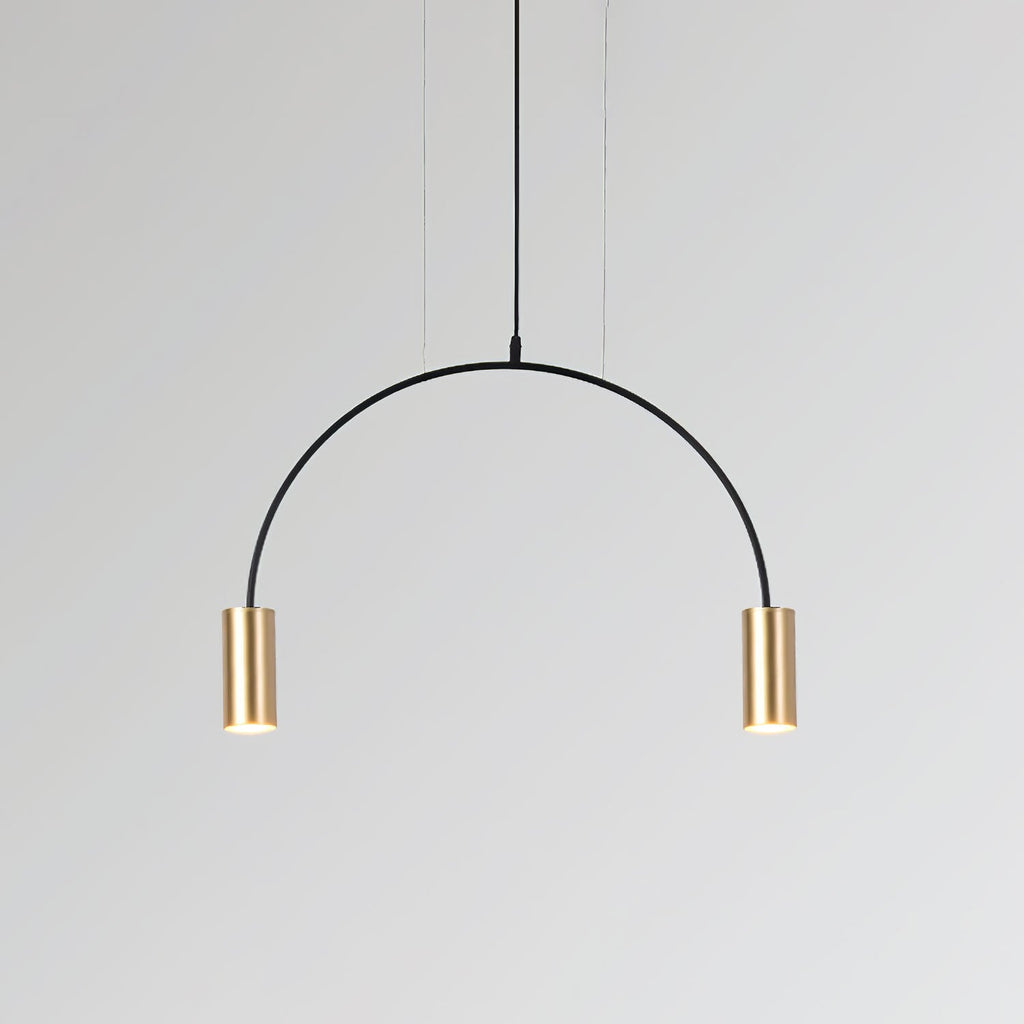 A single black arch carries two brass spot heads on this Clérachic pendant, on a pale grey backdrop.
