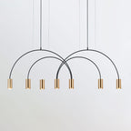 A cluster of brass spot heads hangs under crossing black arches on this Clérachic pendant, on a light grey backdrop.