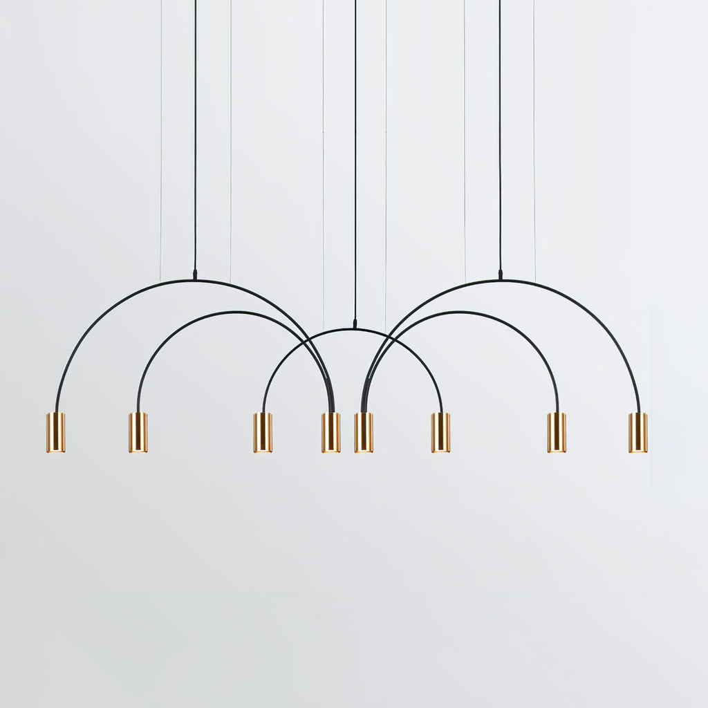Eight brass spot heads hang from four black arches on this Clérachic pendant, on a pale grey backdrop.