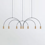 Eight brass spot heads hang from four black arches on this Clérachic pendant, on a pale grey backdrop.